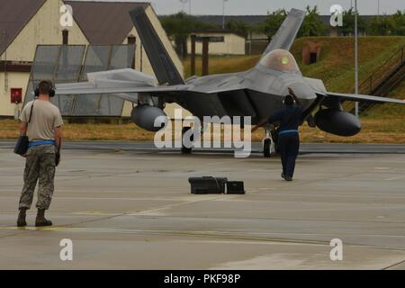 U.S. Air Force F-22 Raptors from the 95th Fighter Squadron, 325th Fighter Wing at Tyndall Air Base, Fla., arrive at Spangdahlem Air Base, Germany, Aug. 8, 2018. The 95th FS is deployed to Europe for several weeks to conduct training with other European-based aircraft as part of a Flying Training Deployment. Forward locations enable collective defense capabilities and provide U.S. and NATO the strategic and operational breadth needed to deter adversaries and assure our allies and partners. Stock Photo