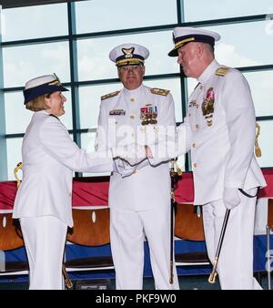 Coast Guard Rear Adm. Meredith Austin shakes hands with Rear Adm. Keith Smith during the 5th District change of command ceremony Aug. 10, 2018, in Norfolk, Virginia. Vice Adm. Scott Buschman, Commander of the Coast Guard Atlantic Area, presided over the ceremony. Stock Photo