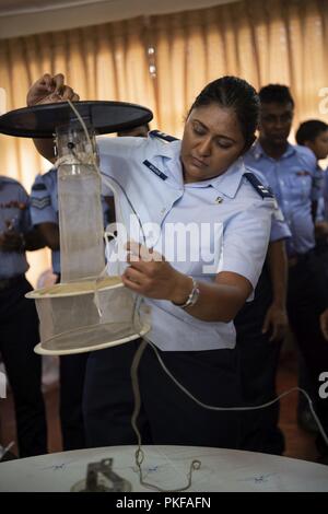 U.S. Air Force Capt. Caroline Brooks, 18th Aerospace Medicine Squadron medical entomologist, builds a mosquito trap during an exchange for Pacific Angel (PAC ANGEL) 18-4, in Anuradhapura, Sri Lanka, Aug. 9, 2018. PAC ANGEL 18 fosters partnerships though multilateral humanitarian assistance and civil military operations, which promote regional cooperation and interoperability. Stock Photo