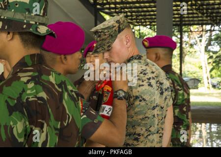 U.S. Marine 1st Lt. Conor Goepel, platoon commander, Kilo Company, 3rd Battalion, 3rd Marine Regiment receives platoon commander recognition from LtCol. Dillianto Bambang, 2nd Battalion, 2nd Korps Marinir (KORMAR) Brigade, during the opening ceremony for the KORMAR Platoon Exchange 2018 program in Cilandak, Indonesia, Aug. 6, 2018. The KORMAR platoon exchange program between Indonesia and the U.S. involves each country sending a platoon of Marines to live and train together at the other's military base. This program enhances the capability of both services and displays their continued commitme Stock Photo