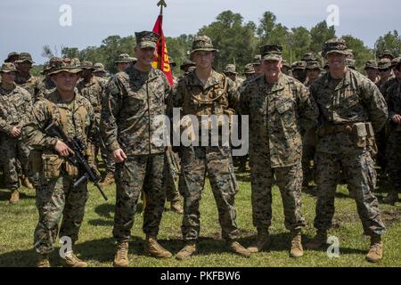 Marine Corps Sgt. Jacob A. Campetilli (middle) with Fox Company, 2nd Battalion, 3rd Marines received a meritorious promotion to sergeant at Malaysian Royal Army Base Kota Belud, Malaysia, August 10th, 2018. CARAT Malaysia in its 24th iteration, is designed to enhance information sharing and coordination, build mutual warfighting capability and support long-term regional cooperation enabling both partner armed forces to operate effectively together as a unified maritime force. Stock Photo