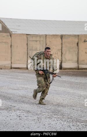 U.S. Army Private 1st Class Maslan, with Bandit Troop, 3rd Cavalry Regiment, conduct the 5-mile ruck march portion of a ranger physical fitness test at Camp Taji, Iraq, July 28, 2018. The 3rd Cavalry Regiment is a trained and ready force, just as it has been for the last 172 years, and our Troopers are answering the Nation’s call to fight and win anywhere in the world. Stock Photo