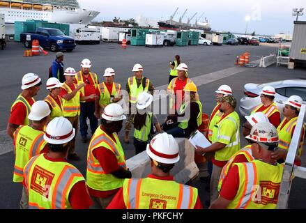 U.S. Army Corps of Engineers Quality Assurance Specialists with the Temporary Emergency Power Planning and Response Teams receive a safety brief, August 11, 2018.      FEMA assigned USACE the Temporary Emergency Power Planning and Response mission to assist with assessments, maintenance, and generator installations at critical facilities, including, but not limited to: hospitals, wastewater treatment plants, water purification facilities, fire, and police stations. USACE has received $676 million to date for this mission. Stock Photo