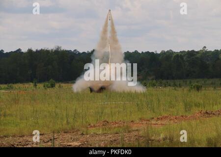 A M1150 Assault Breacher Vehicle fires a M58 Mine Clearing Line Charge toward a countermobility obstacle at Fort Stewart, Ga., August 9. A MK22 Mod 4 Rocket launches 1,750-pounds of C-4 explosive into the air and breaches countermobility obstacles, clearing a path for ground forces to move to the next objective. The ABV and MICLIC are currently field-tested within 9th BEB as part of 2nd Brigade’s transitionary mission set from infantry to armored-based units. Stock Photo