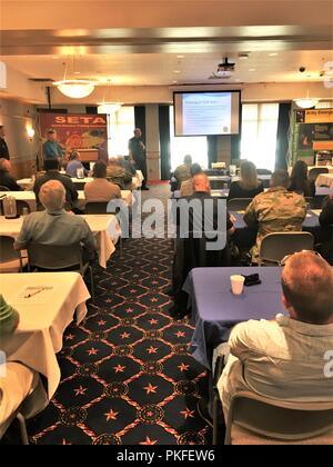 Capt. Blaine Neher with the La Crosse, Wis., Fire Department discusses capabilities of the La Crosse County Hazardous Material Team during the 2018 Threat Management Team meeting Aug. 9, 2018, at McCoy’s Community Center at Fort McCoy, Wis. This was the eighth annual meeting of the team that includes people from Fort McCoy as well as law-enforcement, security, and emergency-service agencies from throughout Wisconsin. The purpose of the meeting and the team is to facilitate networking and to enhance the knowledge of the participants regarding various possible threats in the nation today. Stock Photo