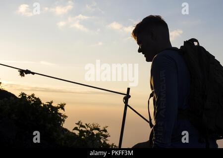 U.S. Marine Corps Lance Cpl. Christian Frolish, a data systems administrator with Marine Wing Support Squadron (MWSS) 171, climbs Mount Fuji during Exercise Eagle Wrath 18, Aug. 2, 2018. Eagle Wrath is an annual training exercise at Combined Arms Training Center Camp Fuji, Japan, designed to increase squadron proficiency in a forward operating environment, test forward command and control structure, and practice for real-world contingency missions. Stock Photo