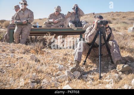 UNDISCLOSED LOCATION, SOUTHWEST ASIA – U.S. Marines with the Sierra 3 scout sniper team of India Company 3rd Battalion 7th Marine Regiment attached to Special Purpose Marine Air-Ground Task Force, Crisis Response-Central Command, complete their range sketches before a known-distance range during Exercise Lucky Seahorse. The sniper team honed their skills on the range and provided over watch for infantry Marines on patrol or clearing buildings during the various scenario-based training evolutions of Lucky Seahorse. Stock Photo