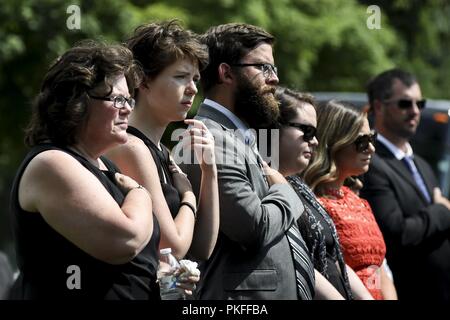 Family members of Chief Master Sgt. Charles Palmer attend a full honors funeral service for him as he’s laid to rest at Arlington National Cemetery, Va., July 27, 2018. Palmer, age 80, passed away at home with his family by his side Dec. 21, 2017. More than 100 family members, friends and SAM Fox Airmen attended the internment to pay their respects. Palmer served in the Air Force for 31 years. He spent 13 of those years serving as a flight attendant on board Air Force One and eleven years as Chief Flight Steward until his retirement in 1986. Palmer served Presidents Richard Nixon, Gerald Ford, Stock Photo