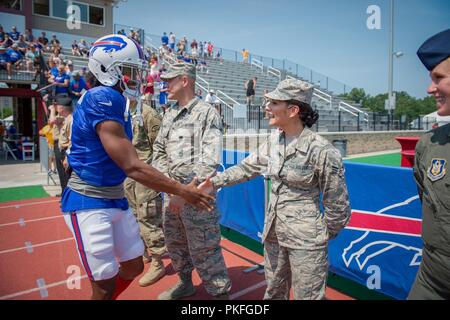 Airman 1st Class Jessica Ramos-Woodard, command support staff assigned to the 107th Operations Group, 107th Attack Wing, New York Air National Guard, shakes hands with Buffalo Bills wide receiver Ray-Ray McCloud III during the Buffalo Bills’ training camp at St. John Fisher College, Rochester, N.Y., Aug. 5, 2018.  Members of military units from Western New York, were invited by the team to participate in NFL’s Military Appreciation Week. Stock Photo