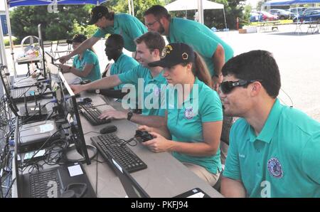 DAHLGREN (Aug. 7, 2018) – The Naval Surface Warfare Center Dahlgren Division (NSWCDD) Sly Fox Mission 23 team in action while demonstrating ARTEMIS - Autonomous Remote Tactical Engagement Multi-Domain Intelligence Swarm – capabilities. Over the past six months, the team used artificial intelligence and machine learning to develop unmanned vehicle swarms that can counteract potential threats of swarming unmanned systems. The Sly Fox program is an NSWCDD Naval Innovative Science and Engineering (NISE) funded rapid prototyping program intended to develop the science and engineering workforce – mo Stock Photo