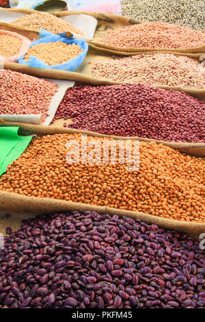 Pulses and Beans Displayed on Burlap Bags on Mexican market Stall Stock Photo