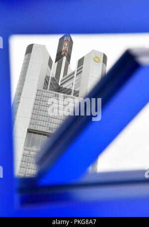 13 September 2018, Hessen, Frankfurt/Main: ILLUSTRATION - 13 September 2018, Germany, Frankfurt/Main: The Commerzbank headquarters can be seen in a mirror with the Deutsche Bank logo. Again and again there is speculation about a merger of the two financial institutions. Photo: Arne Dedert/dpa Stock Photo