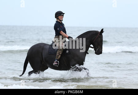 Holkham, Norfolk, UK. 12th Sep 2018. A soldier and her horse from The Kings Troop Royal Horse Artillery enjoying their training on the beach at Holkham, Norfolk, on September 12, 2018. Credit: Paul Marriott/Alamy Live News Stock Photo