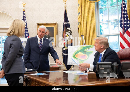 Washington DC, USA. 13th Sep 2018. President Donald J. Trump, joined by Vice President Mike Pence, U.S. Secretary of Homeland Security Kirstjen Nielsen and Rear Admiral Doug Fears, receives an emergency preparedness briefing on Hurricane Florence Thursday, Sept. 13, 2018, in the Oval Office of the White House.  People:  President Donald Trump, Vice President Mike Pence Credit: Storms Media Group/Alamy Live News Stock Photo