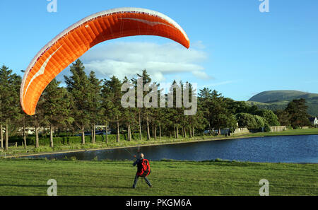 Llanfairfechan boating lake, in Conwy County, with practicing Paraglider. Image taken in June 2018. Stock Photo