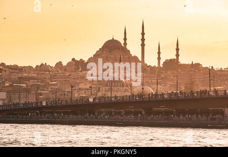 Galata Bridge and Suleymaniye Mosque in the Fatih district at Golden Horn River before sunset, Istanbul, Turkey. Travel concept and Sea front landscap Stock Photo
