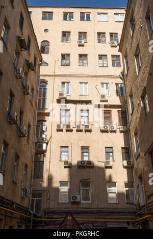 view on 3 biege walls facades in well yard on sunny spring day, Moscow, Russia Stock Photo