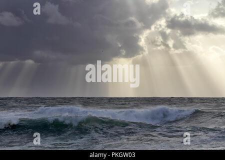 Stormy sea sky with sunbeams between clouds Stock Photo