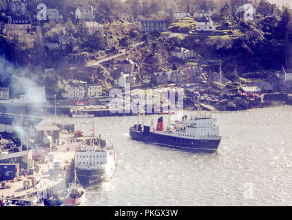 Caledonian MacBrayne (CalMac) Ferry named Claymore sailing out of Oban Harbour in May 1980. Original archival image. Stock Photo