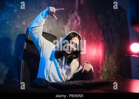 Woman hacker is ready to run malware program virus on the internet. Start hacking remote system computer Stock Photo