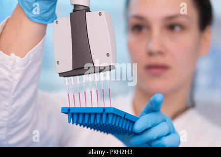 Young woman with genetic research in the laboratory research of cancer diseases Stock Photo