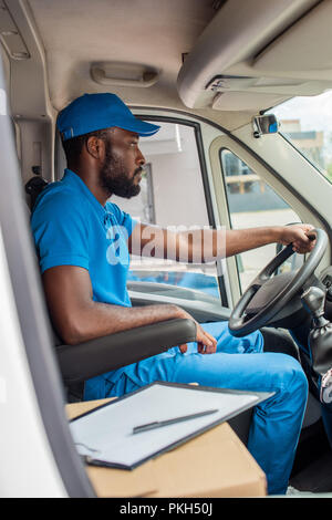 african american delivery man driving van Stock Photo