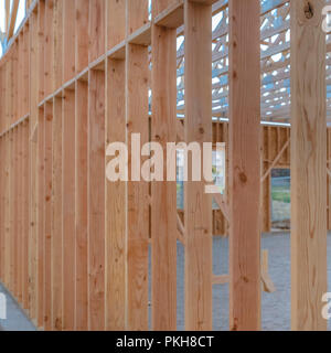 Some vertical wooden beams sandy ground square Stock Photo