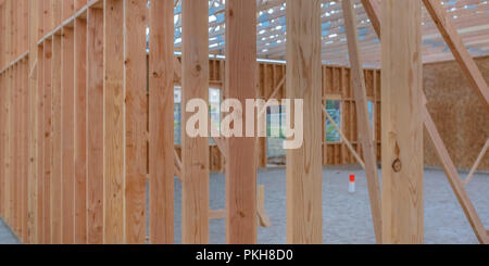 Some vertical wooden beams with sandy ground wide Stock Photo