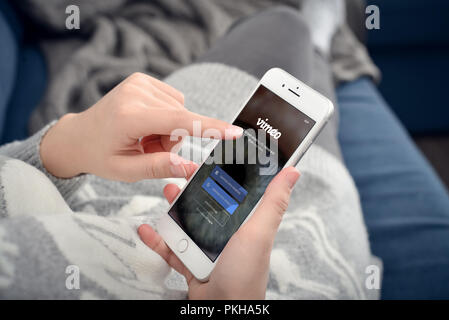 Kyiv, Ukraine - January 24, 2018: Woman holding a brand new Apple iPhone 8 plus with Vimeo network Log In Screen at home closeup Stock Photo