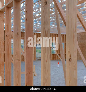 Vertical wooden beams with sandy ground square Stock Photo