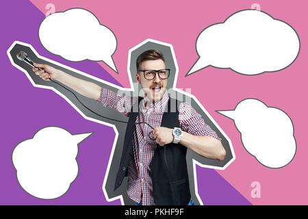 Inscription template karaoke man sings the song to microphone, singer with beard on grey background. Funny man in glasses holding a microphone in his  Stock Photo