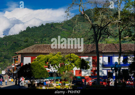 Brightly painted colonial houses are seen on the main plaza in Jardín, a village in the coffee region (Zona cafetera) of Colombia, 30 November 2016. Stock Photo