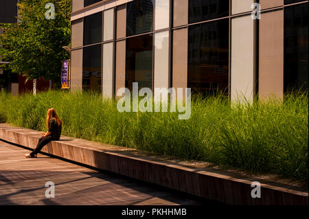 Woman taking a lunch break sitting on bench downtown Seattle. Stock Photo