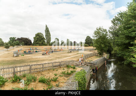 Chelmsford, Essex, UK - July 28, 2018: English families enjoying beautiful sunny Saturday, children playing on the playground and relaxing by the rive Stock Photo