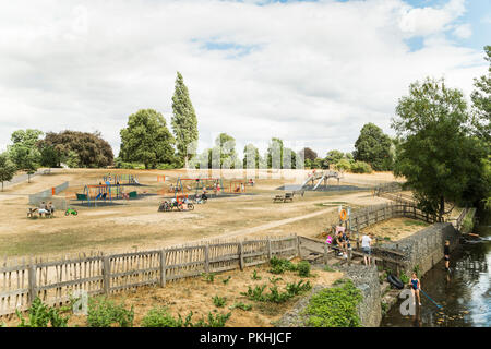 Chelmsford, Essex, UK - July 28, 2018: English families enjoying beautiful sunny Saturday, children playing on the playground and relaxing by the rive Stock Photo