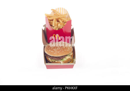 McDonald’s Big Mac takeaway burger with 2 patties, special sauce lettuce and cheese on a sesame seed bun along with french fries Stock Photo