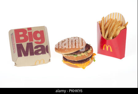 McDonald’s Big Mac burger with 2 patties, special sauce, cheese and lettuce on sesame seed bun with packaging box and french fries or chips Stock Photo