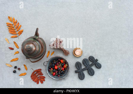 Rustic autumn composition with cozy candlelight. On gray concrete background with copy space. Stock Photo