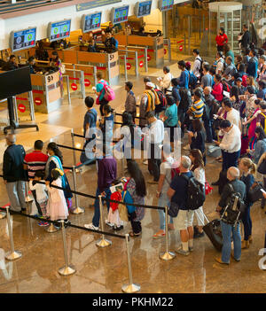 SINGAPORE - JAN 13, 2017: People waiting in queue at arrival immigration of Changi airport. Changi International Airport serves more than 100 airlines Stock Photo
