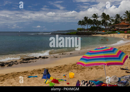 Sunny Poipou Beach Park beach fun island Kauai, Hawaii colorful toys umbrella Stock Photo