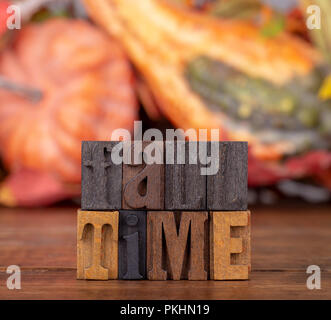 Fall Time message written in wooden blocks with autumn theme background Stock Photo