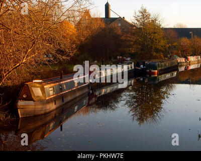 The canal boat moorings at the Maltings in Sawbridgeworth and sunset on a winters evening, the air and water are very still. Stock Photo