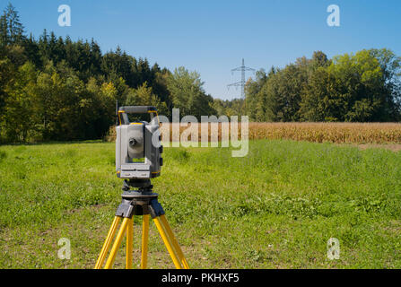 Surveying High Voltage Power Lines - Total Station in the Field Stock Photo