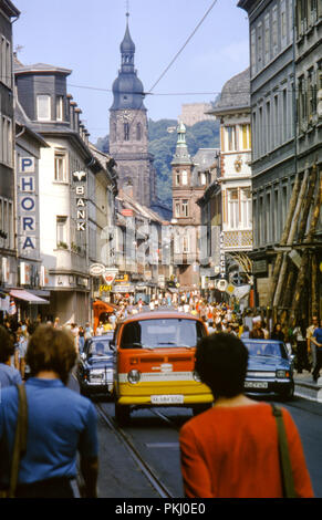 Busy with shoppers and traffic on Hauptstrasse, Altstadt, Heidelberg, Germany taken in August 1973. Original archive photograph. Stock Photo