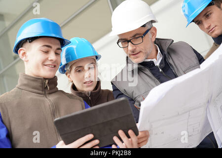 Instructor with young people in engineering training Stock Photo