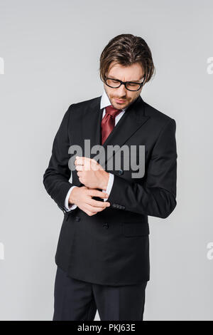 portrait of handsome businessman in stylish suit and eyeglasses isolated on grey Stock Photo