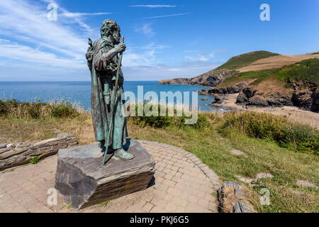 The statue of St Crannog stands overlooking the beach of Llangrannog, Ceredigion, wales Stock Photo