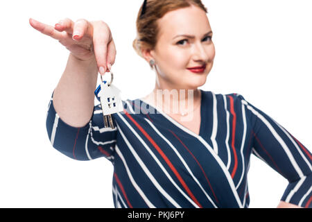 selective focus of female realtor showing keys from house isolated on white background Stock Photo
