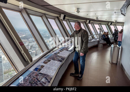 People enjoy the stunning views over Berlin from the observation deck at the top of the TV Tower,  Berlin Fernsehturm, in Alexanderplatz. Stock Photo