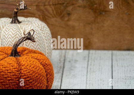 Fabric fall pumpkins - orange and white - wooden background. Concept for fall Stock Photo